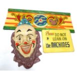 A fairground papier mache clown, with open game, poly chrome decorated predominantly in red orange