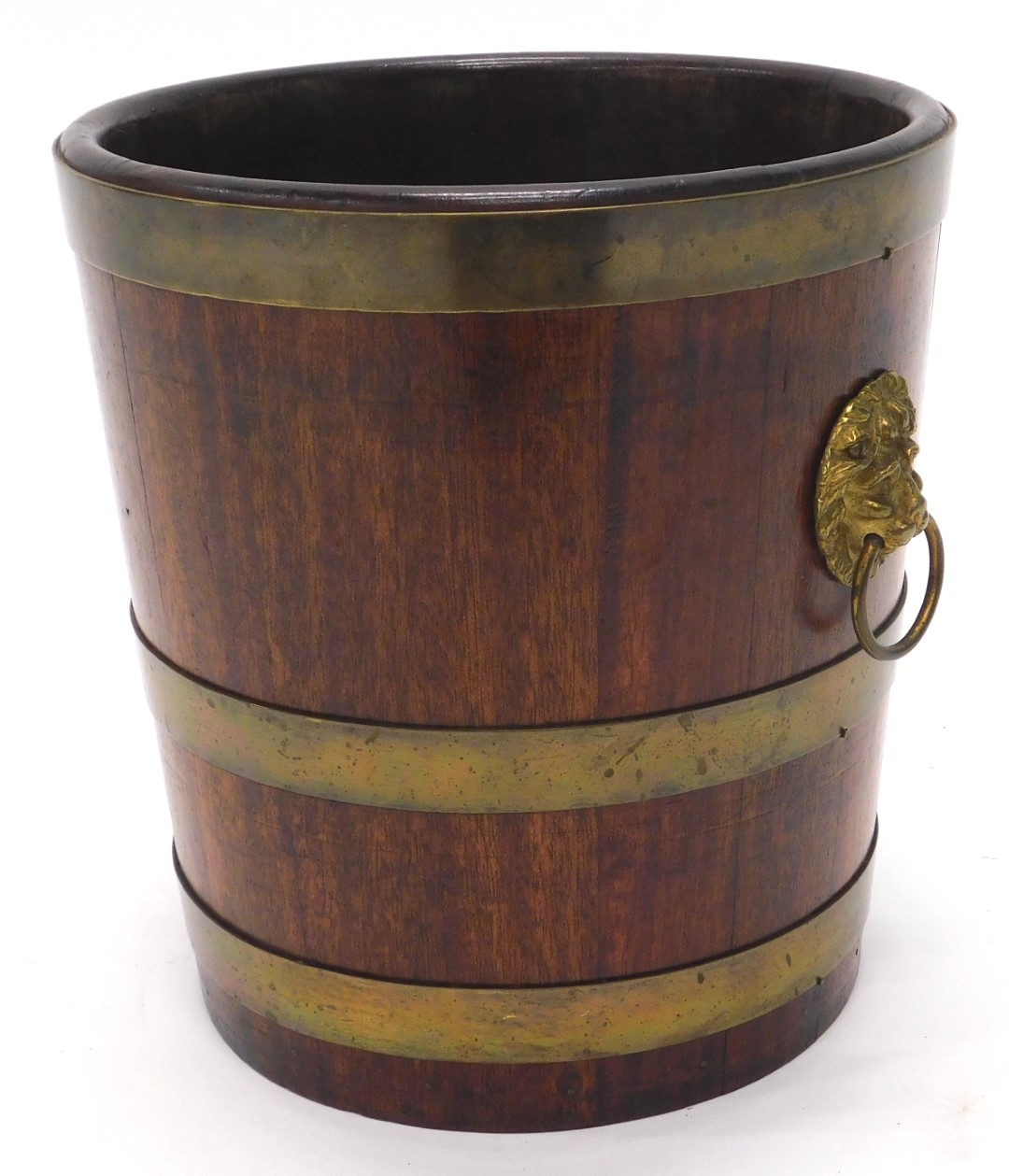 A 19thC mahogany and brass coopered waste paper basket or jardiniere, with gilt metal lion mask