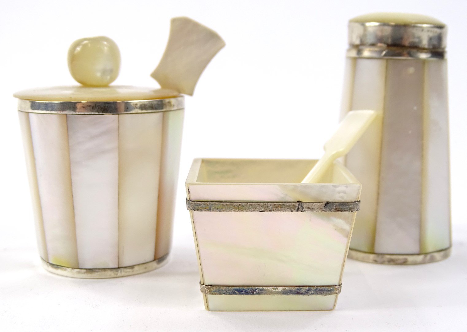 A mother of pearl white metal preserve set, to include salt pot 9cm high, shaped spoon etc. (a