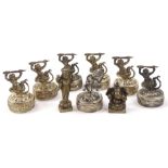 A set of seven Indian God and Warrior statues, on shaped circular feet, each repousse decorated,