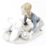 A 20thC Lladro figure of a girl feeding geese, no.4849, on a shaped base, printed and impressed