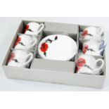 A Wedgwood boxed Susie Cooper design Corn Poppy pattern part coffee service, comprising of six