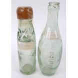 An early 20thC shaped bottle, press moulded with raised name R M Mills & Co, with registered trade