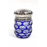 An Edwardian silver blue and clear flash glass perfume jar, with hammered removable lid, London