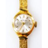 A 9ct gold Walker Astron ladies wristwatch, with small circular silvered dial, on polished design