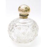 An Edwardian silver and cut glass dressing table perfume bottle, the bulbous body heavily hobnail