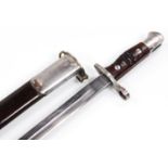 A 1913 pattern bayonet, with wooden handle, polished metal end and leather and metal scabbard,