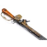 A reproduction flintlock pistol knife gun, with shaped textured blade and turned wooden handle