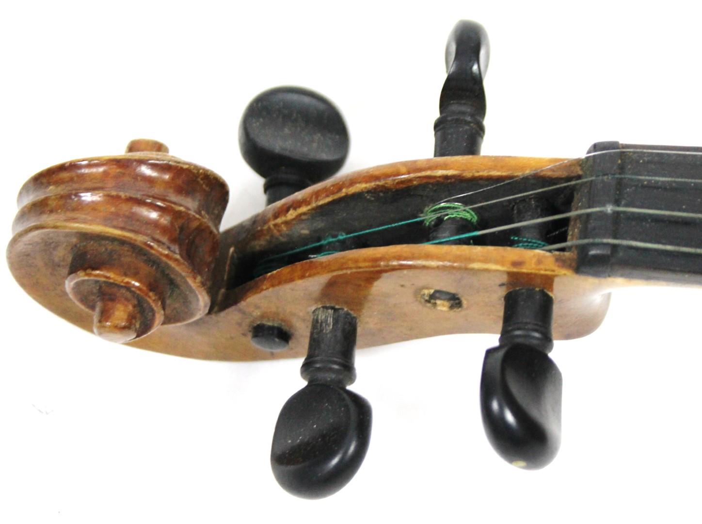 A 20thC pine violin, with two piece polished back, ebonised articulated tuning knops and a scroll - Bild 3 aus 9