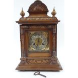 A late 19thC German walnut mantel clock, the square brass dial with silvered chapter ring with