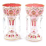 A pair of 19thC Bohemian milk ruby and coloured glass lustres, each with castellated bowl tops,