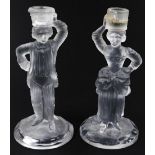 A pair of frosted and clear glass candlesticks, probably American, formed as a lady and gentleman,