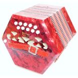 A Bastari Italian squeeze box, in red mother of pearl finish, with two banks of five buttons to each