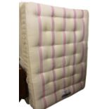 A Churchill Dreams Sleepeezee 54" mattress, in pink and cream colour way, on a Divan base.