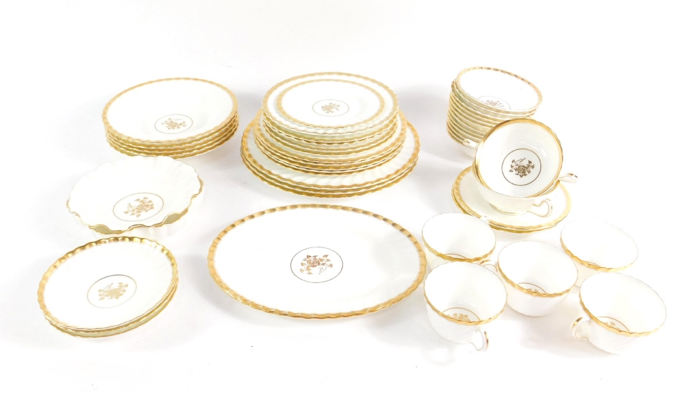 A Minton porcelain part dinner and tea service decorated in the Gold Rose pattern, including dinner,