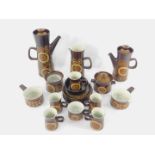 A group of Denby pottery decorated in the Arabesque pattern, including two graduated coffee pots,