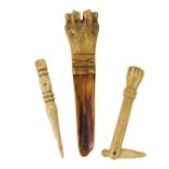 A Georgian carved bone apple corer, 19thC bone folding pocket knife carved as a human lower arm, and