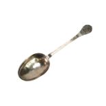 A Queen Anne West Country lace-back and dog-nose spoon, decorated to the front of the terminal and