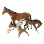 A Beswick brown gloss horse, together with two ponies, and a Goebel figure of a terrier. (4)