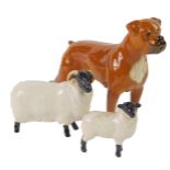 A Beswick pottery figure modelled as a Boxer dog, together with two figures of sheep. (3)