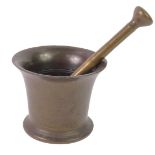 A bronze pestle and mortar.