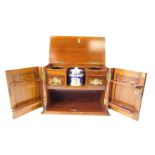 A Victorian oak smoker's cabinet, with twin brass carrying handles, a pair of carved panelled