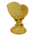 A Royal Worcester porcelain nautilus shell vase, c1934, raised on a coral and shell stem and