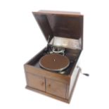 An HMV model 109 oak cased table top gramophone, with a No 4 stylus retailed by Wilson Peck,