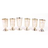 A set of five Russian early 20thC silver Kiddusch cups, with engraving of buildings and foliage,
