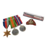A group of WWII medals, comprising 1939 and 45 Star, Defence and War Medals, a ribbon bar, a West