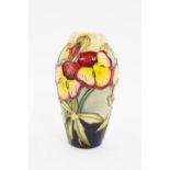 A Moorcroft Pottery vase, decorated with flowers against a cream to blue ground, limited edition