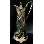 An Art Nouveau style claret jug, copying a WMF example, green glass and white metal overlaid as a