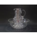 An early 20thC cut glass wash jug and bowl, jug 34cm high, bowl 39cm dia.