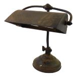 An early 20thC copper and cast iron angular desk lamp, raised on a circular base, 35cm high.