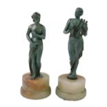 A pair of cast metal figures modelled as Venus and Erato, green verdigris type finish, raised on