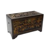 A Chinese camphorwood chest, carved overall with battle scenes, buildings etc., 91cm W.