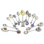 A collection of presentation spoons, some silver, some white metal, and some silver plated.