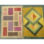 A small rag weave rug, with a design of rectangles and squares in multiple colours on a cream