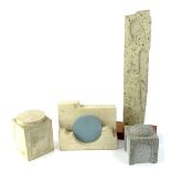 Four carved stone sculptures, to include a monolith type sculpture on a wooden base, 51cm H.