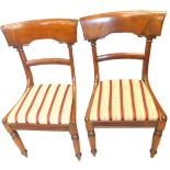 A pair of George IV mahogany dining chairs, each with a bar back, with column supports, drop in