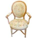 An early 20thC French fauteuil, with walnut frame, upholstered in floral wool work to the back arms,