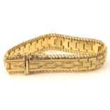 A gold plated bracelet, with etched and beaded design, with sliding clip clasp, with faint