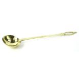 A heavy brass ladle, the handle stamped WM, 50cm L.