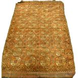 A Bokhara carpet, with a design of four rows of medallions on a red ground, 275cm x 180cm.