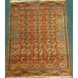 A Bokhara rug, with a design of three rows of medallions on a red ground, 160cm x 123cm.