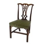 A George III mahogany dining chair in Chippendale style, with a pierced splat, padded serpentine