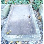 A hewn stone rectangular sink, with rounded corner to one end, 102cm W.
