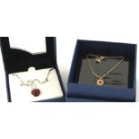 Two Swarovski crystal necklaces, to include a silver plated Swarovski set apple pendant on box