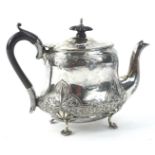 An Edward VII small bachelor type tea pot, with embossed and repousse decoration of scrolls, leaves,