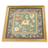 A 20thC Chinese silk embroidery, decorated with vases of flowers, flowers etc., within a floral